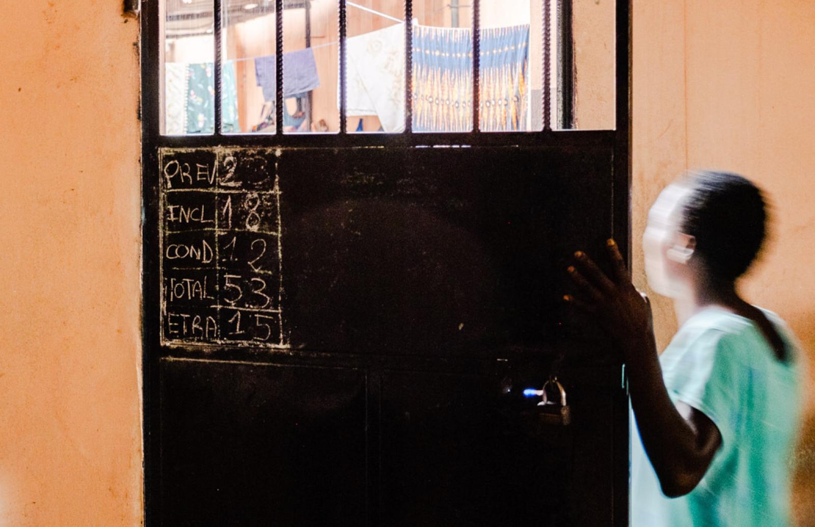 woman leaving cell door