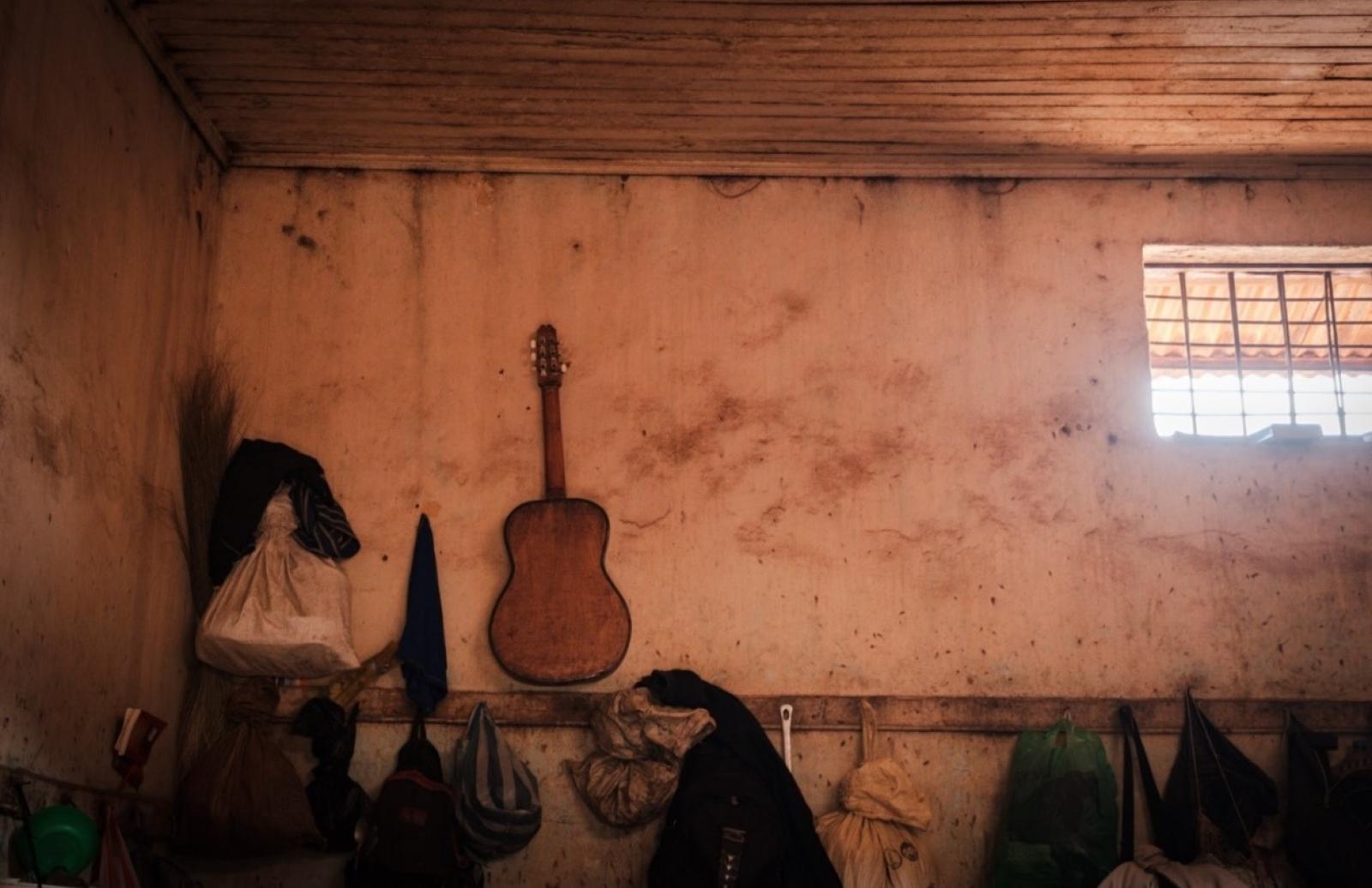 A guitar on the wall of a prison cell